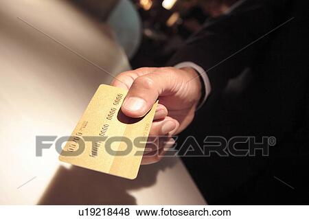 Stock Photo - Japanese executive checking by credit card. Fotosearch
