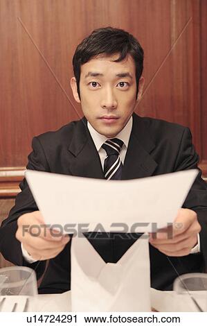 Japanese office worker handing a document View Large Photo Image Stock Image - Japanese office worker handing a document. Fotosearch