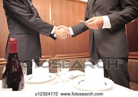 Japanese office workers shaking hands View Large Photo Image Stock Image - Japanese office workers shaking hands. Fotosearch