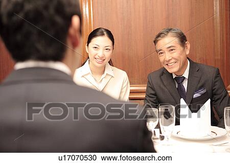 Stock Image - Scene of dinner meeting. Fotosearch