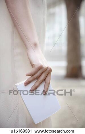 Holding a notepad View Large Photo Image Stock Image - Holding a notepad. Fotosearch