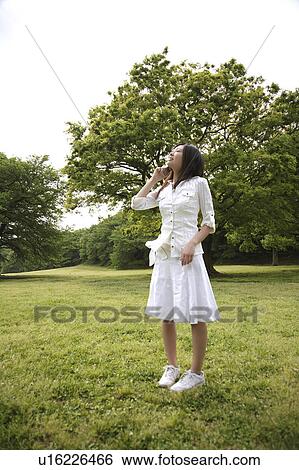 Stock Photograph - Japanese woman talking with a cell phone. Fotosearch