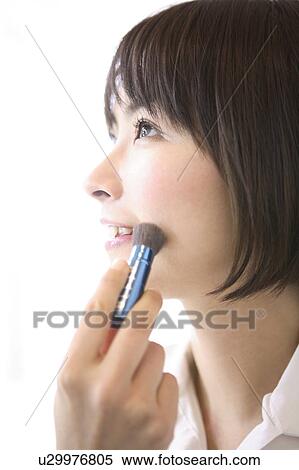 Stock Photography - Woman applying makeup. Fotosearch