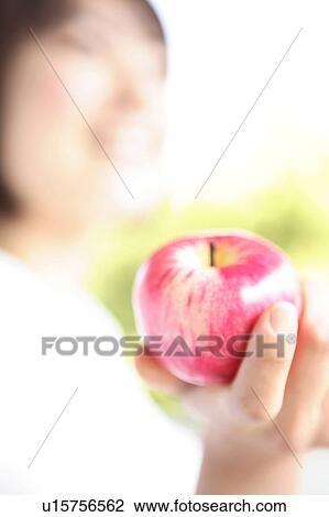 Woman holding apple View Large Photo Image Stock Image - Woman holding apple. Fotosearch