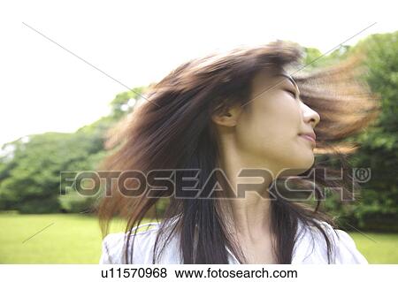 Stock Photo - Woman shaking hair loose. Fotosearch