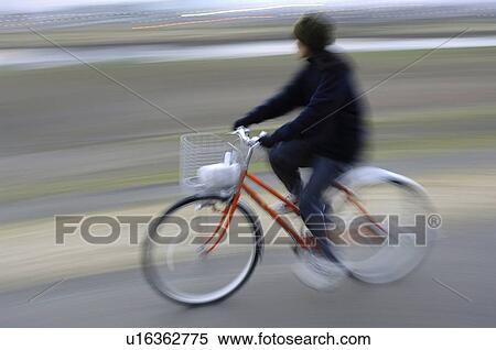 Blurred image of woman riding bicycle View Large Photo Image Stock Photography - Blurred image of woman riding bicycle. Fotosearch