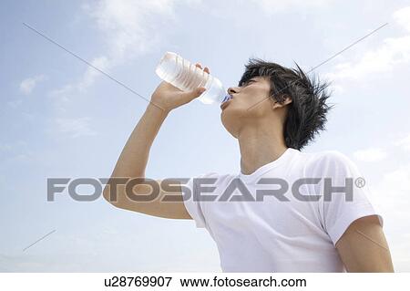 Stock Photo - Japanese man drinking a water. Fotosearch
