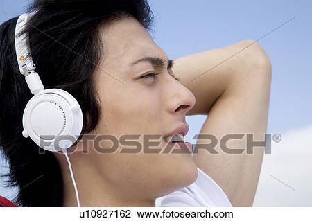 Japanese man listening to music View Large Photo Image Stock Image - Japanese man listening to music. Fotosearch
