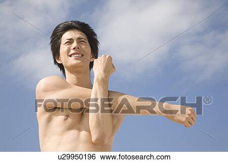 Stock Photograph - Japanese man stretching arms. Fotosearch