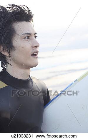 Stock Image - Japanese surfer in Enoshima beach. Fotosearch