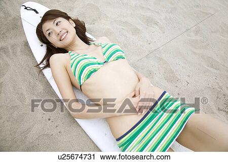 Japanese woman lying on a beach in swimsuit View Large Photo Image Stock Image - Japanese woman lying on a beach in swimsuit. Fotosearch