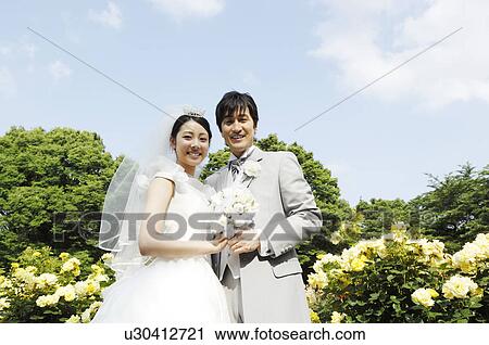 Stock Image - Bridal couple below the blue sky. Fotosearch