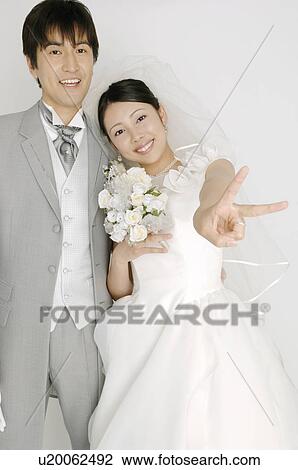 Bridal couple giving peace sign View Large Photo Image Stock Image - Bridal couple giving peace sign. Fotosearch
