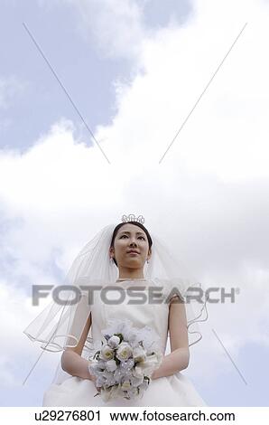 Stock Image - Bride below the blue sky. Fotosearch