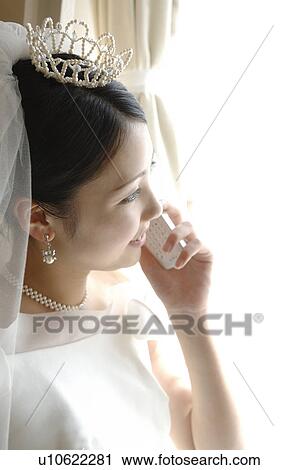 Bride talking with cell phone View Large Photo Image Stock Image - Bride talking with cell phone. Fotosearch