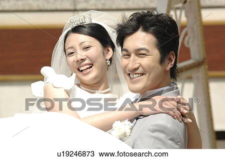 Bridegroom lifting a bride View Large Photo Image Stock Image - Bridegroom lifting a bride. Fotosearch