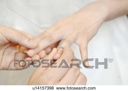 Stock Photo - Exchange of the ring. Fotosearch