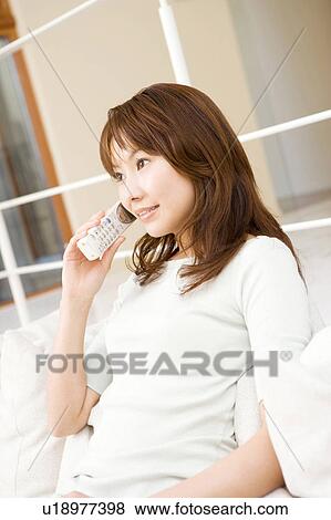 Stock Photo - Japanese woman talking with a cell phone. Fotosearch