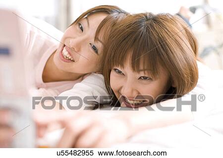Japanese women looking at cell phone View Large Photo Image Stock Photography - Japanese women looking at cell phone. Fotosearch
