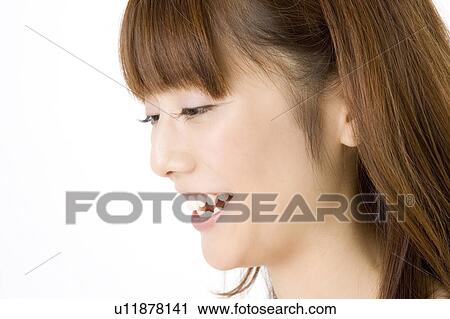 Side view of smiling woman View Large Photo Image Stock Image - Side view of smiling woman. Fotosearch