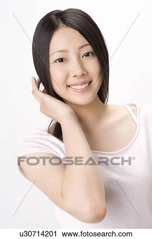Studio portrait of smiling young woman View Large Photo Image Stock Image - Studio portrait of smiling young woman. Fotosearch