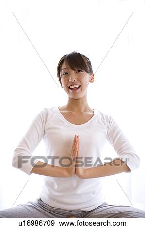 Stock Photo - Young woman doing yoga. Fotosearch