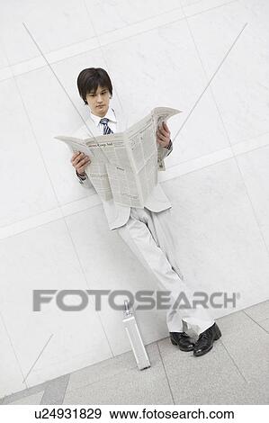 Stock Photo - Business man reading a newspaper. Fotosearch