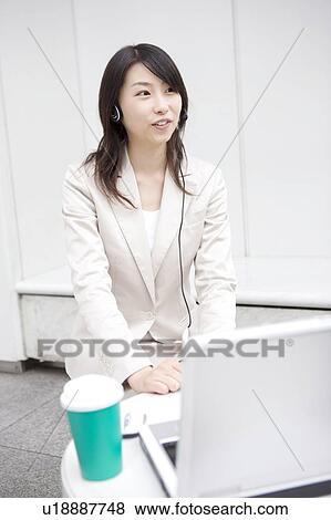 Stock Photo - Business woman talking with headset. Fotosearch