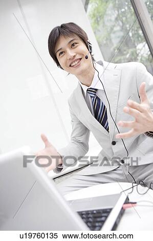 Stock Photography - Businessman talking with headset. Fotosearch