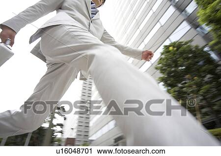 Stock Image - Businessman walking. Fotosearch