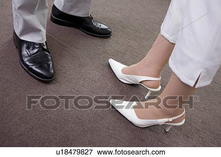 Stock Photo - Feet of business man and business woman. Fotosearch