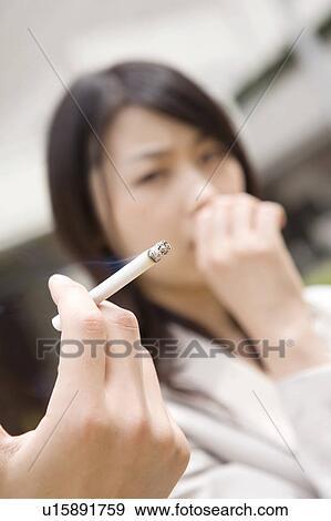 Stock Photo - Hand holding cigarette. Fotosearch