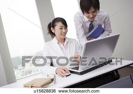 Office coworkers with laptop View Large Photo Image Stock Photograph - Office coworkers with laptop. Fotosearch