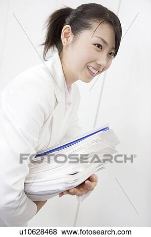 Stock Photo - Office lady carrying many documents. Fotosearch