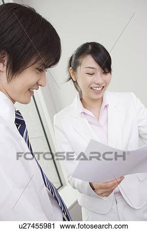 Stock Image - Office worker checking a document. Fotosearch