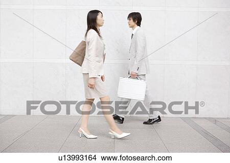 Office workers going by each other View Large Photo Image Picture - Office workers going by each other. Fotosearch