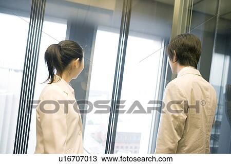 Office workers taking an elevator View Large Photo Image Stock Image - Office workers taking an elevator. Fotosearch