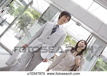 Stock Photography - Office workers walking along together. Fotosearch