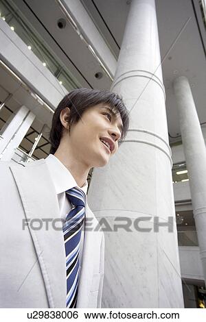 Stock Photograph - Portrait of young office worker. Fotosearch