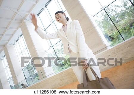 Woman waving a hand View Large Photo Image Stock Photo - Woman waving a hand. Fotosearch