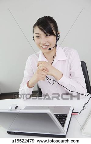 Stock Photo - Woman wearing headset. Fotosearch