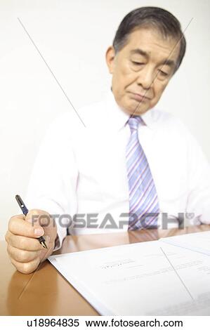 Chief executive officer checking a document View Large Photo Image Stock Photography - Chief executive officer checking a document. Fotosearch