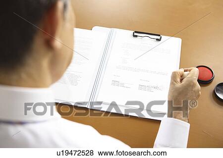 Stock Photo - Chief executive officer pushing the stamp. Fotosearch