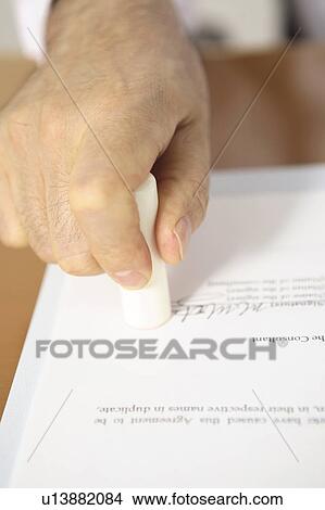Picture - Hand of chief executive officer pushing the stamp. Fotosearch