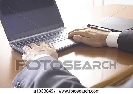 Stock Photo - Hands of office worker operating a PC. Fotosearch
