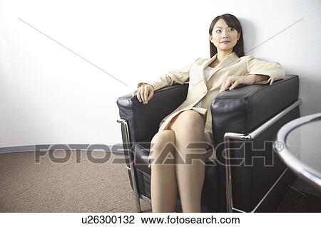 Office lady sitting on a sofa View Large Photo Image Stock Image - Office lady sitting on a sofa. Fotosearch