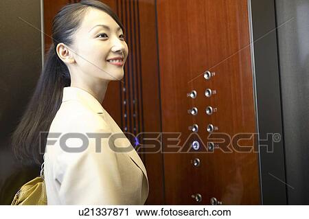Office worker in an elevator View Large Photo Image Stock Image - Office worker in an elevator. Fotosearch