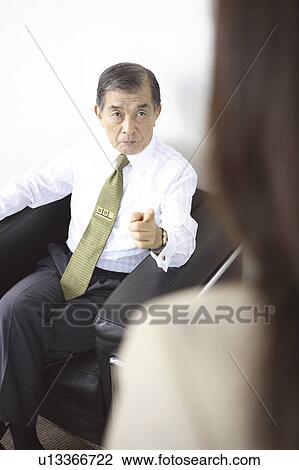 Stock Image - President scolding a secretary. Fotosearch