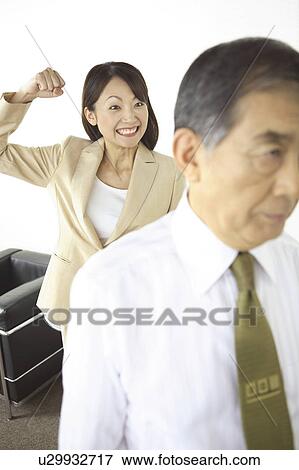 Stock Photo - Secretary pretending to strike CEO. Fotosearch