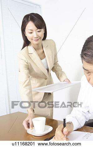 Secretary serving a coffee View Large Photo Image Stock Image - Secretary serving a coffee. Fotosearch